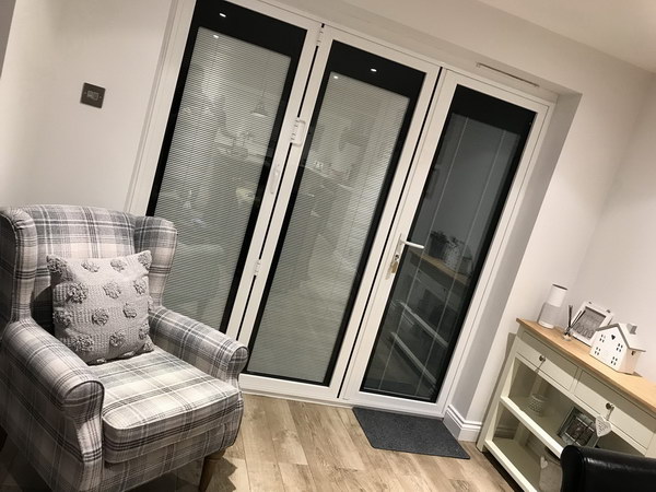 Beige Grey venetian integral blinds with a fully dressed perimeter in jet black...